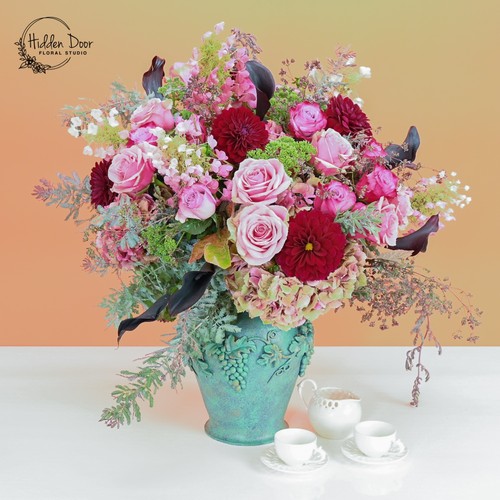 Pink roses and burgundy dahlias with eucalyptus in a teal vintage urn by Durham flower studio