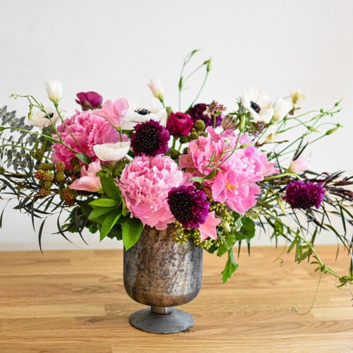 Pink peonies white anemones and dark scabiosa in a pewter urn arranged by flower studio Durham
